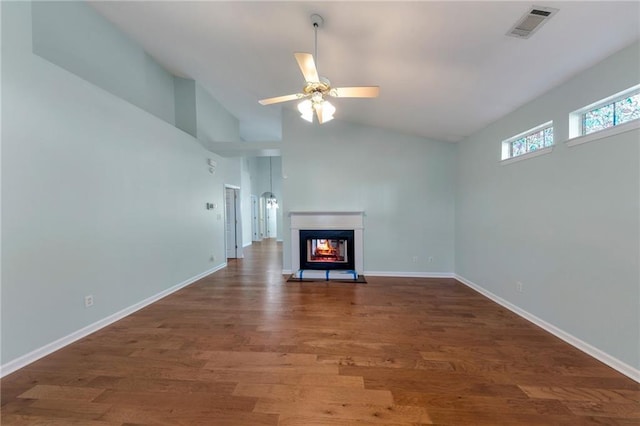 unfurnished living room with lofted ceiling, dark hardwood / wood-style floors, ceiling fan, and a multi sided fireplace