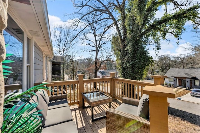 wooden terrace featuring outdoor lounge area