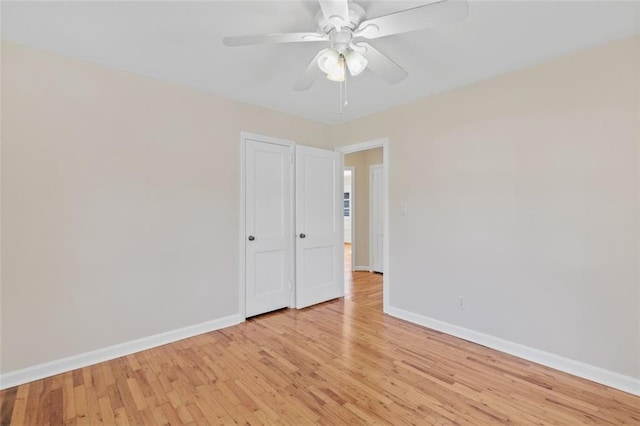 spare room featuring light hardwood / wood-style flooring and ceiling fan