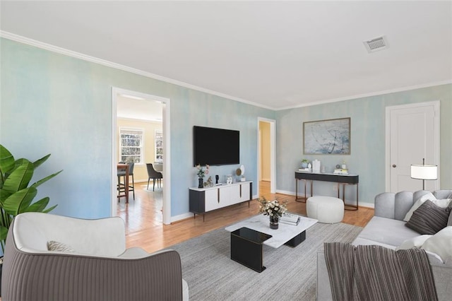 living room featuring ornamental molding and light hardwood / wood-style floors