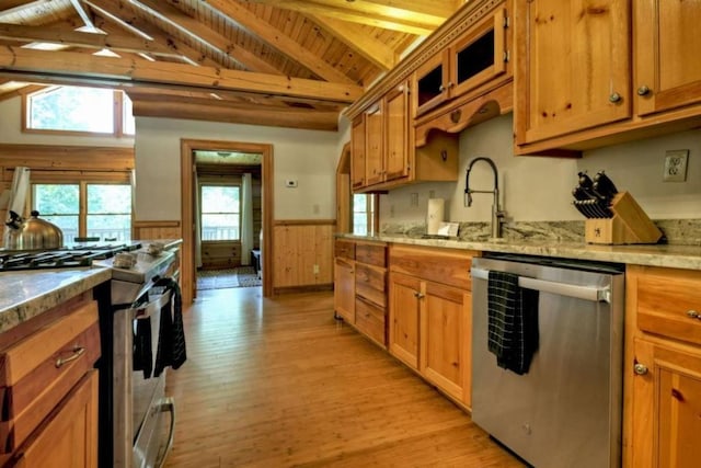 kitchen with vaulted ceiling with beams, a wainscoted wall, light wood-style flooring, wooden ceiling, and stainless steel appliances