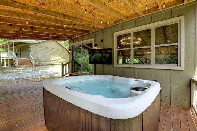 wooden deck with a hot tub