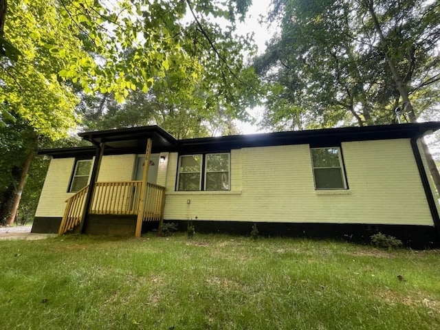 rear view of property with a yard