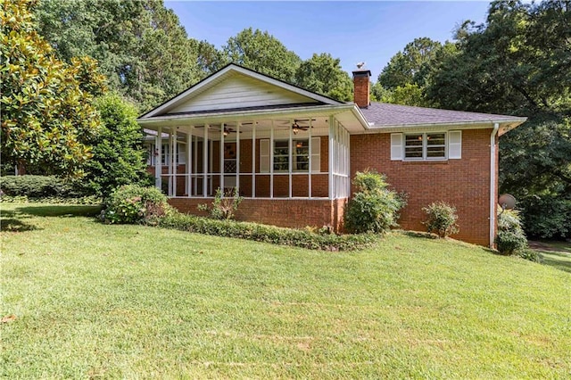 5670 Lanny Dr, Powder Springs, GA 30127 - view of front of house featuring a chimney, a front lawn, brick siding, and a sunroom