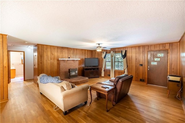 5670 Lanny Dr, Powder Springs, GA 30127 - living room with a textured ceiling, light wood-type flooring, ceiling fan, and wood walls