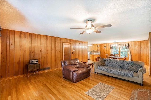 5670 Lanny Dr, Powder Springs, GA 30127 - living room featuring ceiling fan, wood finished floors, wooden walls, and a textured ceiling