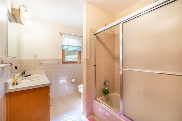 5670 Lanny Dr, Powder Springs, GA 30127 - bathroom with tile walls, vanity, enclosed tub / shower combo, tile patterned floors, and wainscoting