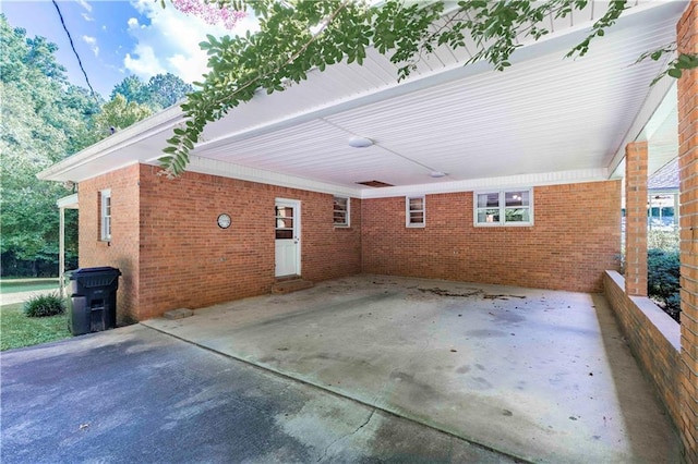 5670 Lanny Dr, Powder Springs, GA 30127 - rear view of house with an attached carport, brick siding, and a patio area
