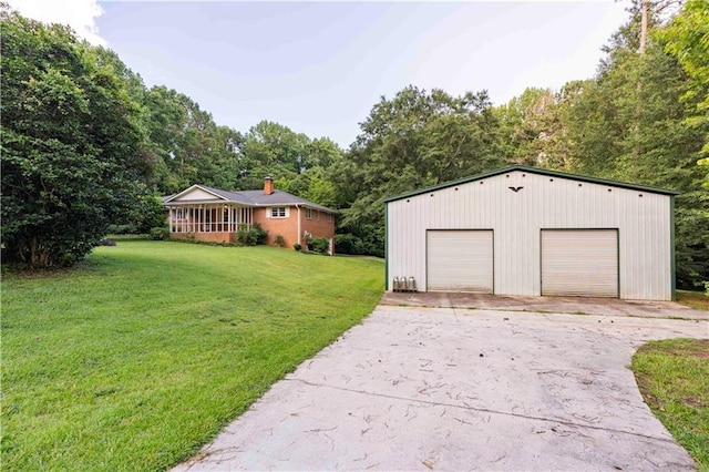 5670 Lanny Dr, Powder Springs, GA 30127 - view of grassy yard featuring a detached garage and an outbuilding