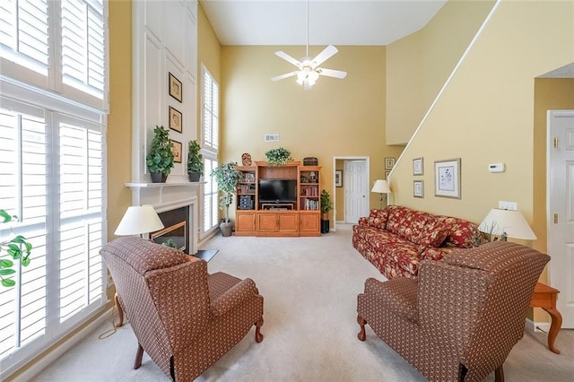626 Dahoma Trl, Woodstock, GA 30188 - living area with light colored carpet, high vaulted ceiling, ceiling fan, and a glass covered fireplace