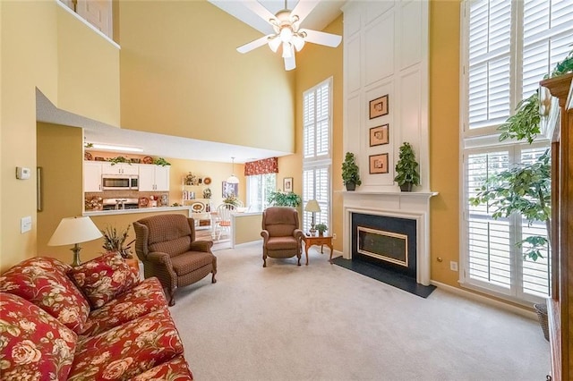 626 Dahoma Trl, Woodstock, GA 30188 - living room with a high ceiling, carpet, ceiling fan, and a fireplace