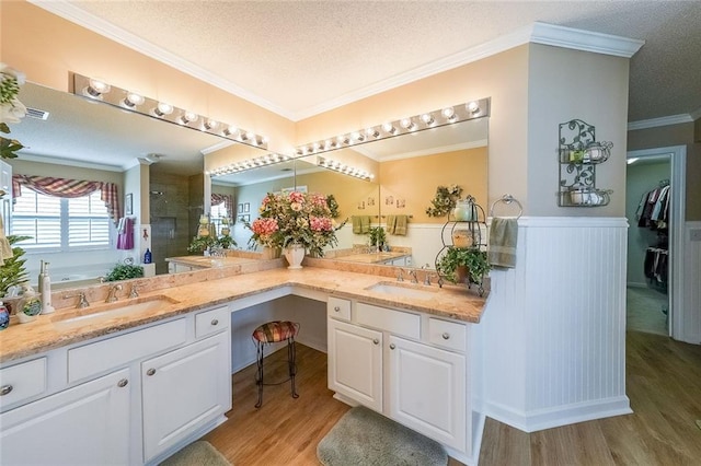 626 Dahoma Trl, Woodstock, GA 30188 - bathroom featuring wood finished floors, a shower stall, double vanity, a garden tub, and wainscoting