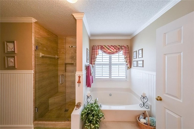 626 Dahoma Trl, Woodstock, GA 30188 - bathroom featuring a garden tub, wainscoting, a shower stall, a textured ceiling, and crown molding