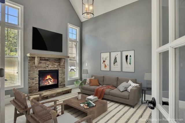 1231 Fawndale Dr NW, Kennesaw, GA 30152 - living area featuring high vaulted ceiling, healthy amount of natural light, a stone fireplace, and carpet floors