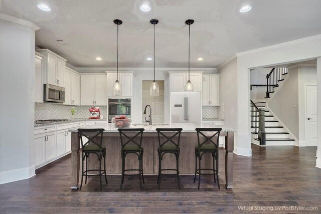 1231 Fawndale Dr NW, Kennesaw, GA 30152 - kitchen with appliances with stainless steel finishes, a sink, decorative backsplash, ornamental molding, and white cabinets