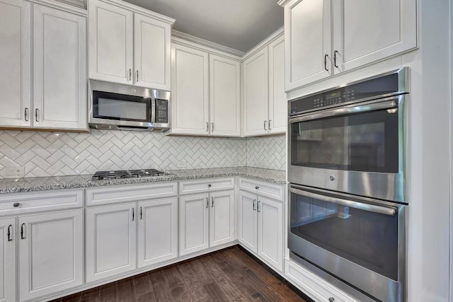 1231 Fawndale Dr NW, Kennesaw, GA 30152 - kitchen featuring stainless steel appliances, white cabinetry, light stone counters, tasteful backsplash, and dark wood-type flooring