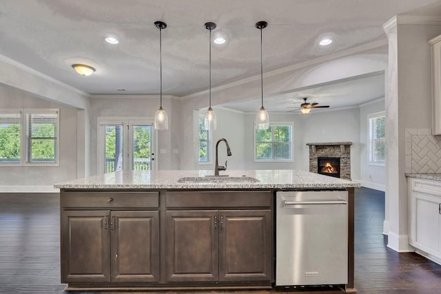 1231 Fawndale Dr NW, Kennesaw, GA 30152 - kitchen featuring a sink, a stone fireplace, a ceiling fan, dark wood-style flooring, and ornamental molding