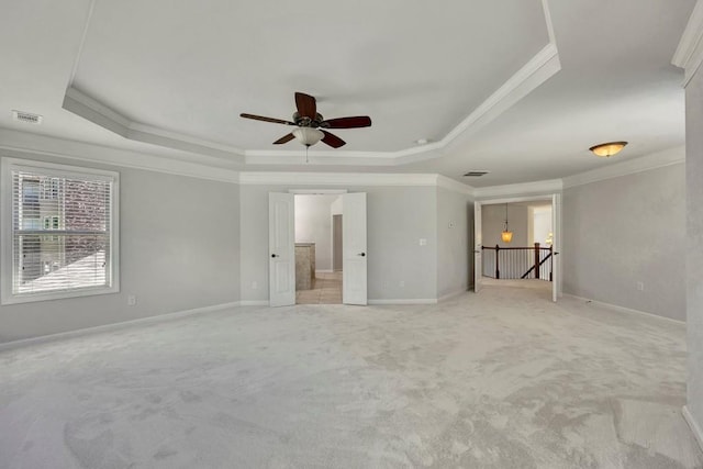1231 Fawndale Dr NW, Kennesaw, GA 30152 - unfurnished living room featuring a tray ceiling, ornamental molding, light colored carpet, a ceiling fan, and baseboards