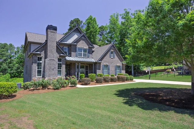 1231 Fawndale Dr NW, Kennesaw, GA 30152 - craftsman house featuring brick siding, a chimney, a front yard, and a standing seam roof