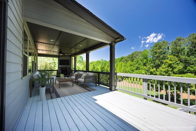 1231 Fawndale Dr NW, Kennesaw, GA 30152 - wooden deck featuring a ceiling fan and an outdoor living space with a fireplace