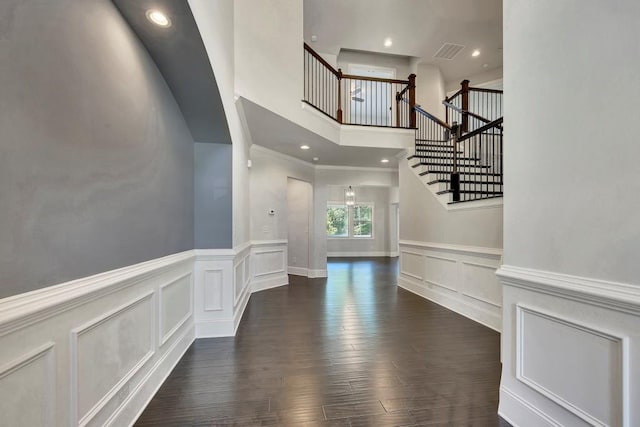 1231 Fawndale Dr NW, Kennesaw, GA 30152 - stairs with a decorative wall, wood finished floors, a wainscoted wall, a towering ceiling, and recessed lighting
