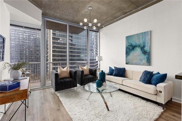 living room featuring expansive windows, wood-type flooring, and a chandelier