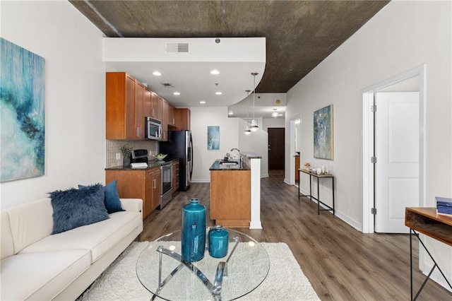 living room featuring dark hardwood / wood-style flooring and sink