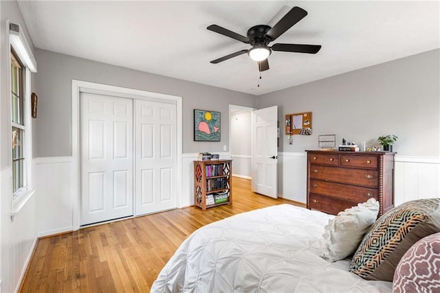 bedroom with ceiling fan, a closet, and light wood-type flooring