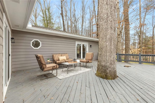 wooden terrace with outdoor lounge area