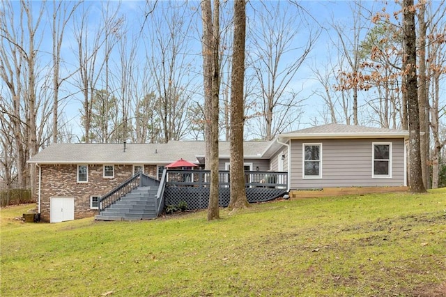 back of house with a deck and a lawn