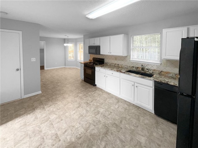 kitchen featuring black appliances, white cabinetry, backsplash, and sink