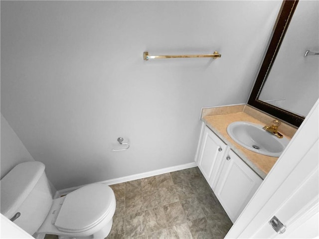 bathroom featuring toilet and vanity