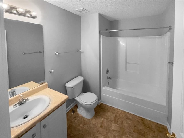 full bathroom with toilet, a textured ceiling, tub / shower combination, and vanity