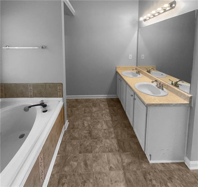 bathroom featuring tiled bath and vanity