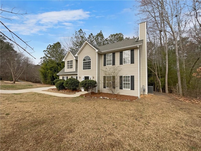 view of front of property featuring central AC and a front lawn