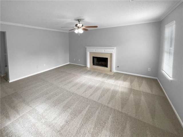 unfurnished living room with carpet flooring, a textured ceiling, ceiling fan, and crown molding