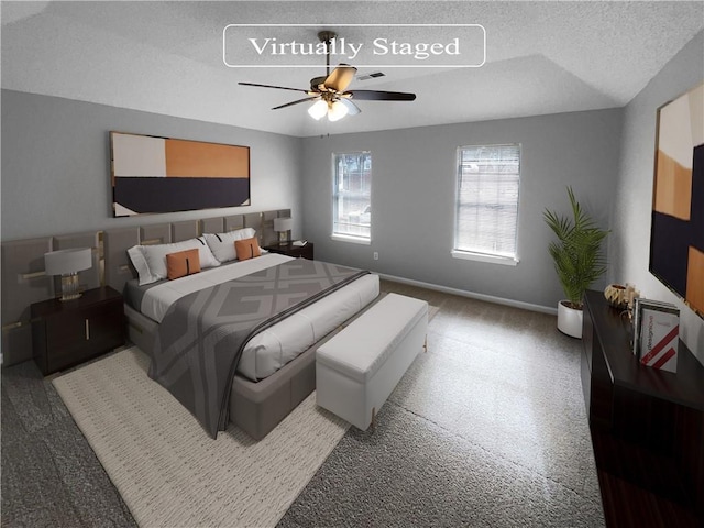 bedroom with a textured ceiling and ceiling fan