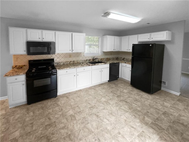 kitchen featuring sink, white cabinetry, black appliances, and light stone countertops