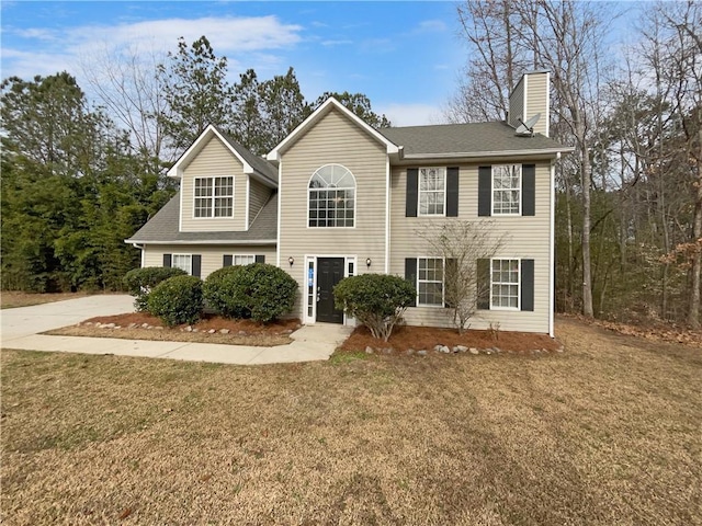 colonial-style house with a front lawn