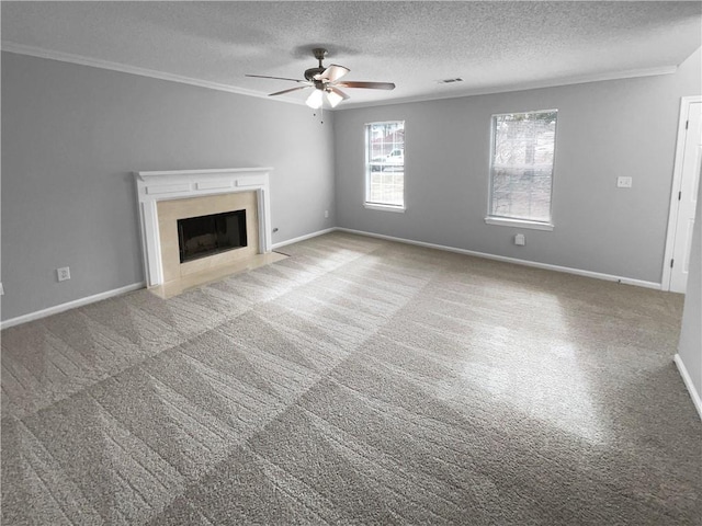 unfurnished living room with a textured ceiling, ceiling fan, crown molding, and light colored carpet