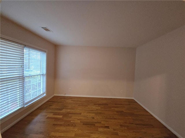 unfurnished room featuring dark hardwood / wood-style flooring