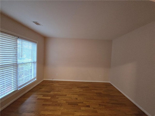 empty room featuring dark wood-type flooring