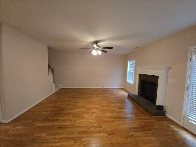 unfurnished living room featuring ceiling fan and hardwood / wood-style floors