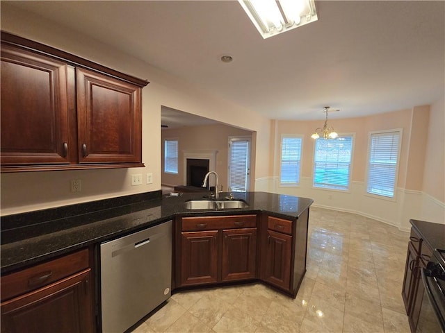 kitchen with dark stone counters, dishwasher, and sink