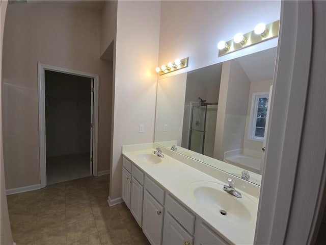 bathroom featuring vanity, tile patterned floors, and plus walk in shower