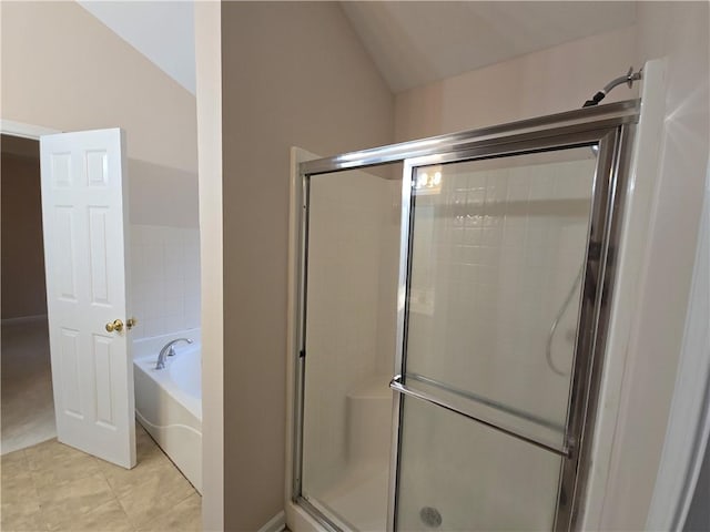 bathroom with independent shower and bath, lofted ceiling, and tile patterned floors