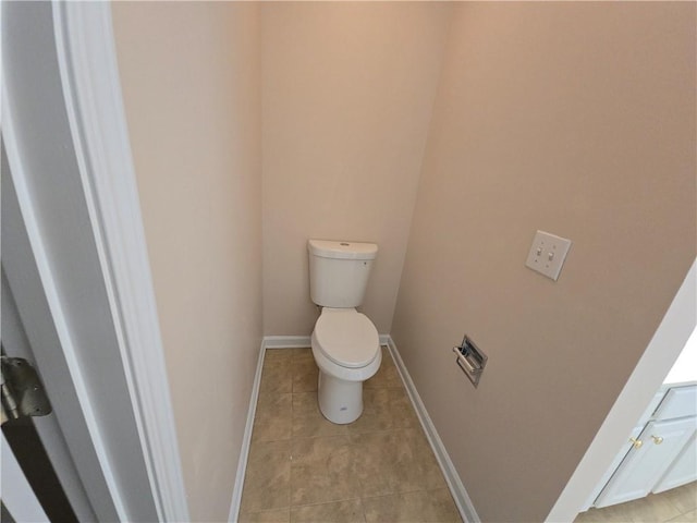 bathroom featuring toilet and tile patterned flooring