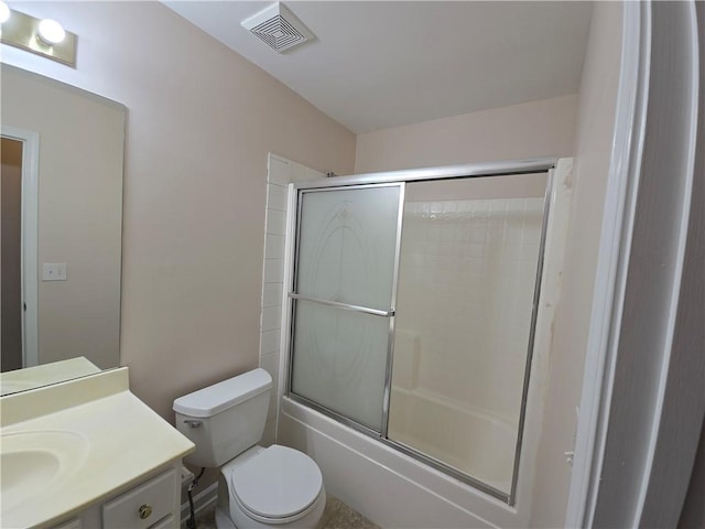 full bathroom featuring vanity, toilet, and combined bath / shower with glass door