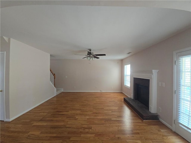 unfurnished living room with hardwood / wood-style flooring and ceiling fan