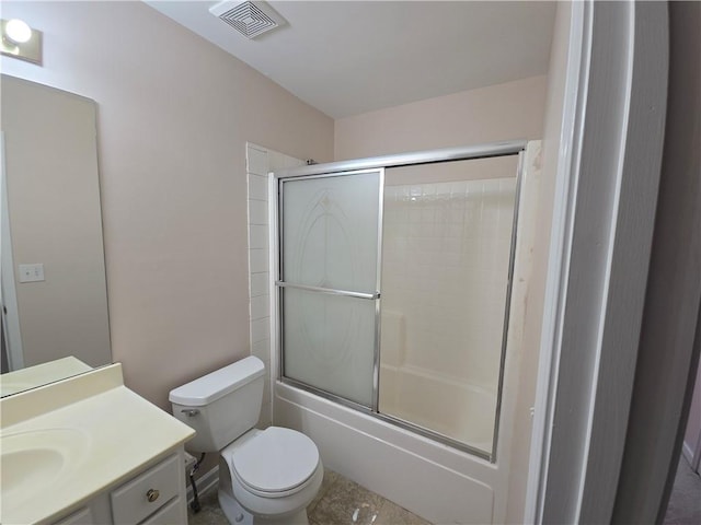 full bathroom featuring vanity, shower / bath combination with glass door, and toilet